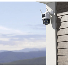 Caméra de surveillance avec antennes montée sur un mur de maison