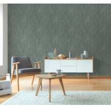 Wohnzimmer mit strukturierten Tapeten, Sessel, Sideboard und Tisch