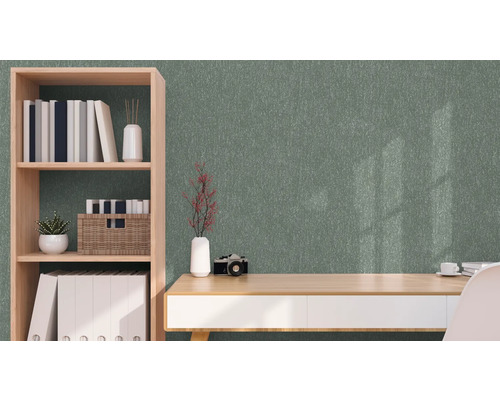 Zimmer mit grüner Strukturtapete, Schreibtisch und Bücherregal
