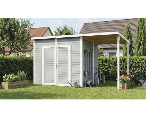 Abri de jardin avec annexe et outils de jardin dans le jardin