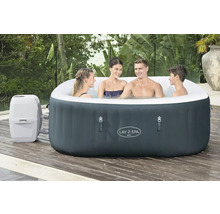 Bain à remous gonflable Lay-Z-Spa Ibiza avec quatre personnes sur une terrasse en bois.