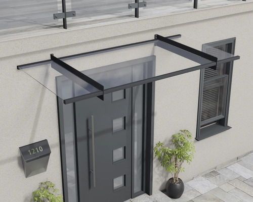 Marquise de porte moderne en verre avec un cadre en métal noir au-dessus d'une porte d'entrée.