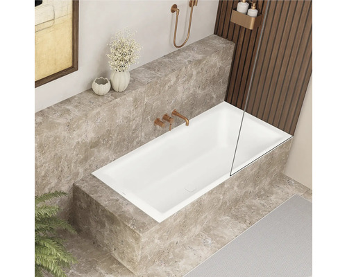 Badezimmer mit rechteckiger Badewanne, Armaturen und Fliesen in Marmoroptik