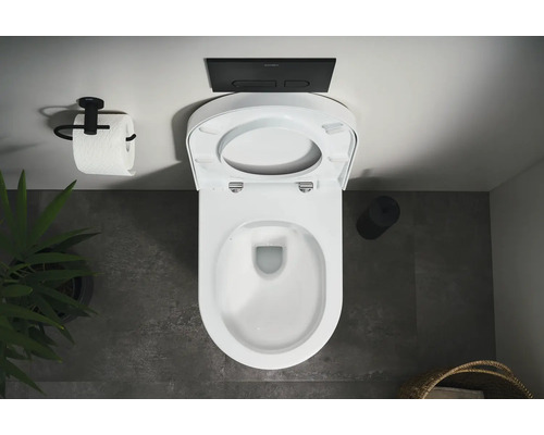 Vue de dessus de toilettes avec abattant ouvert, plaque de commande et support papier toilette