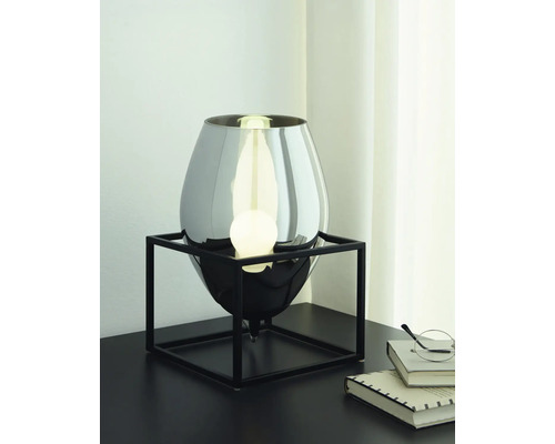 Dekorative Tischleuchte mit Metallfuß und Lampe auf einem Tisch