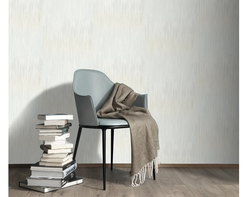 Décoration murale avec papier peint, chaise, couverture et pile de livres pour une ambiance chaleureuse