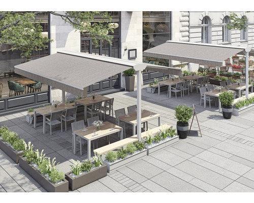 Extérieur d'un restaurant avec des auvents, des tables, des chaises et des jardinières.