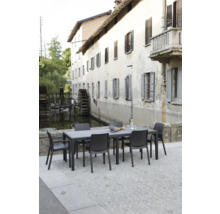 Ensemble de meubles de jardin avec table et chaises devant un décor historique