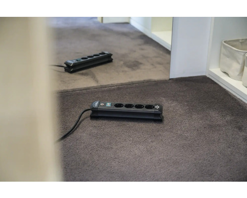 Steckdosenleiste mit fünf Anschlüssen auf Teppichboden