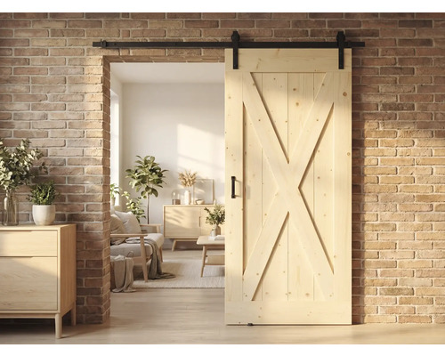 Porte coulissante en bois avec motif en X dans un intérieur rustique