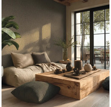 Pièce lumineuse et minimaliste avec canapé au sol, table en bois rustique et céramiques. Grande baie vitrée et plante, ambiance organisée.