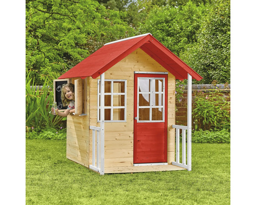 Cabane de jeu en bois avec toit et porte rouges dans le jardin avec enfant à la fenêtre