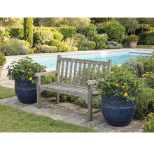 Scène de jardin avec banc en bois et pots de fleurs près d'une piscine