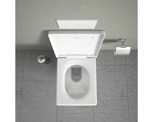 Vue de dessus de toilettes blanches avec réservoir et porte-papier hygiénique