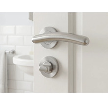 Ensemble de garnitures de porte avec poignée et bouton rotatif sur une porte blanche