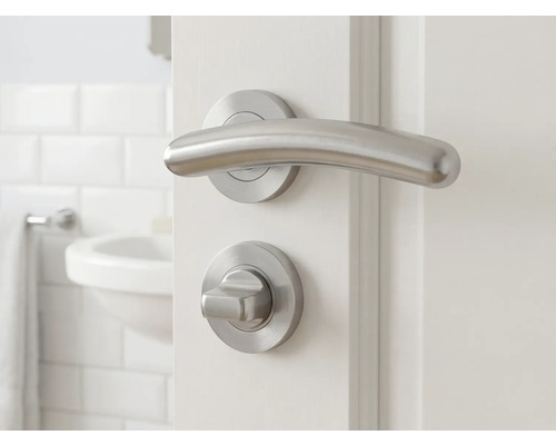 Ensemble de garnitures de porte avec poignée et bouton rotatif sur une porte blanche