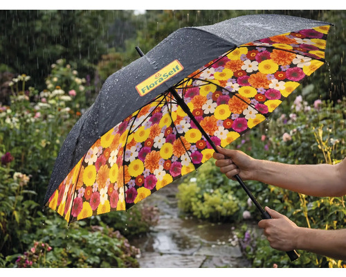 Parapluie dans un jardin pluvieux avec extérieur noir, FloraSelf Logo et motif floral coloré à l'intérieur.