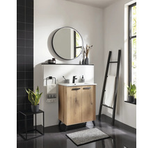 Salle de bains moderne avec meuble sous lavabo en bois, lavabo blanc, robinet noir, miroir rond et échelle porte-serviettes noire.