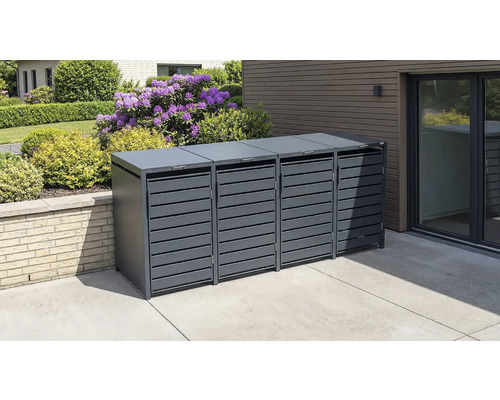 Moderne Mülltonnenbox für vier Tonnen aus Metall in Anthrazit mit Lamellentüren auf einer gepflasterten Terrasse neben einem Garten.