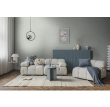 Salon moderne lumineux avec canapé modulaire blanc, buffet bleu, mur gris, tapis clair et table d'appoint ronde.