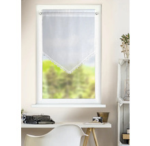 Rideau de vitrage blanc transparent avec bordure en pointe et dentelle crochetée au-dessus d'un bureau avec machine à écrire dans une pièce claire.