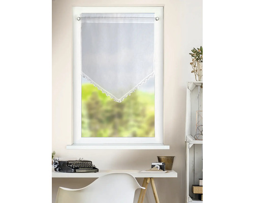 Rideau de vitrage blanc transparent avec bordure en pointe et dentelle crochetée au-dessus d'un bureau avec machine à écrire dans une pièce claire.