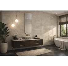 Salle de bain moderne avec carrelage mural aspect marbre, meuble sous-vasque sombre, vasque à poser, miroir ovale et baignoire en îlot.