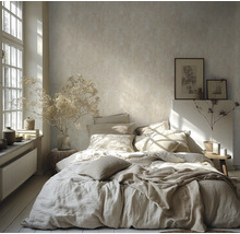 Chambre lumineuse avec papier peint texturé, lit avec linge de lit en lin, fleurs séchées dans des vases et grande fenêtre pour la lumière naturelle.