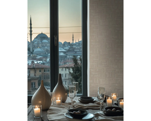 Gedeckter Tisch mit Keramikvasen, brennenden Kerzen und Gläsern vor einem Fenster mit Stadtblick und beige strukturierter Tapete.