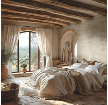 Chambre rustique avec poutres en bois, murs texturés, sol en pierre et grande fenêtre en arche offrant une vue sur le paysage.