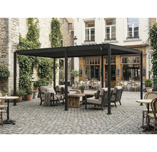Pergola autoportante en aluminium avec toit à lames, salon de jardin avec table en bois sur une cour pavée.