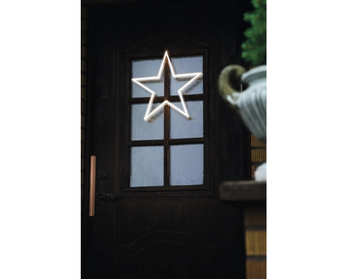 LED-Stär an Neon-Optik als Chrëschtbeleuchtung un enger donkeler Holztir mat Glas.