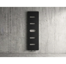 Radiateur design vertical noir avec découpes ovales sur un mur en béton.