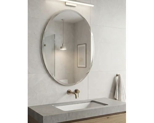 Salle de bains moderne avec un miroir mural ovale, un plan de toilette en béton avec vasque intégrée et une robinetterie murale.