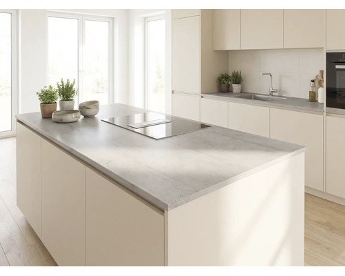 Cuisine moderne et lumineuse avec un grand îlot central, un plan de travail gris aspect béton et une plaque de cuisson avec hotte intégrée.