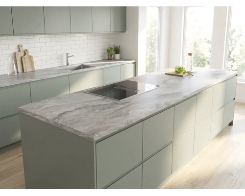 Cuisine moderne lumineuse avec îlot, meubles vert sauge, plan de travail aspect marbre et crédence en carrelage blanc.