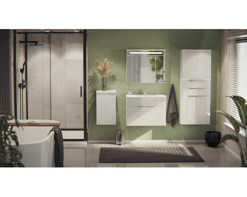 Helles, modernes Badezimmer mit weißem Waschtisch, Hochschrank, Dusche, Badewanne und Spiegel mit Beleuchtung vor einer grünen Wand.