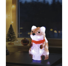 Figurine lumineuse en acrylique representant un ecureuil avec echarpe rouge sur une table, decoration de Noel avec sapin en fond.