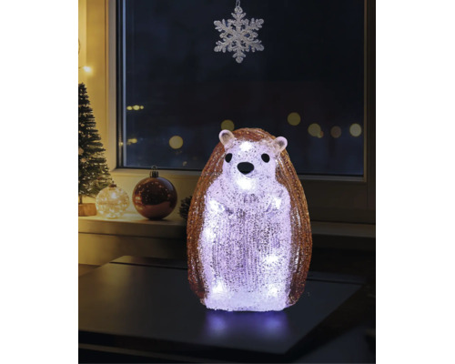 Figurine de hérisson décorative à LED en acrylique avec une surface cristalline, posée sur une table dans une pièce décorée pour Noël.