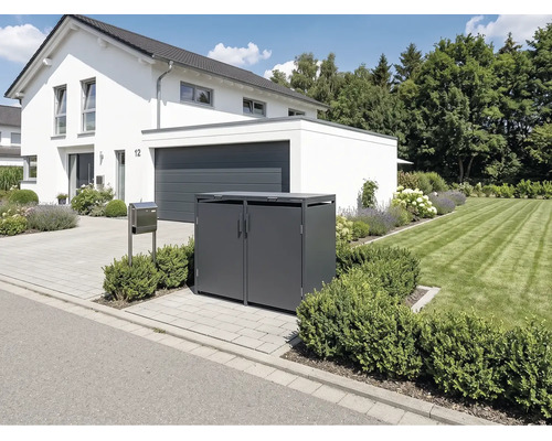 Abri pour deux poubelles moderne en métal anthracite devant une maison blanche avec allée pavée et pelouse.