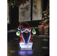 Gnome de Noël LED avec effet miroir infini sur une table devant une fenêtre hivernale avec sapin et cadeau.