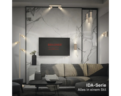 Salon moderne avec luminaires Briloner série IDA: lampadaire, plafonnier, suspension et appliques murales devant un mur aspect marbre.