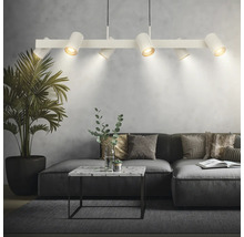 Suspension blanche moderne avec six spots réglables au-dessus d'un canapé gris dans un salon avec table en marbre et plante d'intérieur.