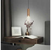 Suspension cylindrique en bois au-dessus d'un bureau avec un livre et un vase.