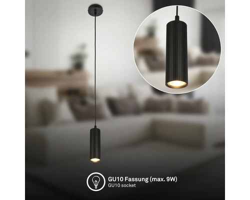 Suspension cylindrique noire avec structure rainurée, douille GU10 pour maximum 9 watts dans un salon.