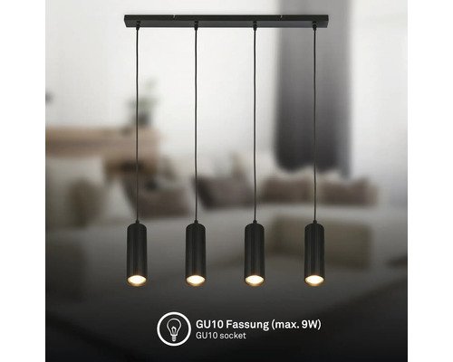 Suspension à 4 lampes en noir avec abat-jour cylindriques nervurés au-dessus d'un canapé. Douille GU10, maximum 9 watts.