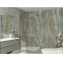 Salle de bains moderne avec douche à l'italienne, paroi en verre, robinetterie bronze, carrelage aspect pierre, meuble gris et lavabo blanc.