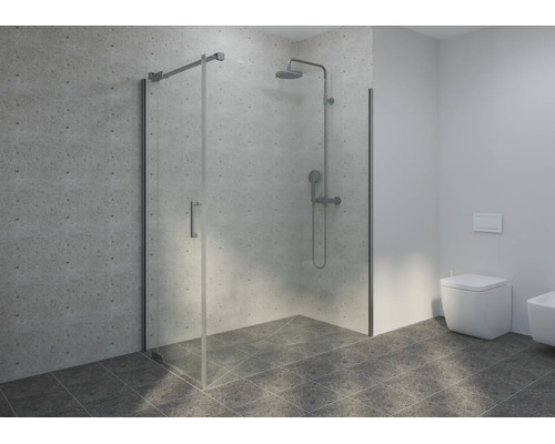 Cabine de douche moderne en verre avec robinetterie chromée, carrelage mural gris clair et carrelage de sol gris foncé dans une salle de bain claire.