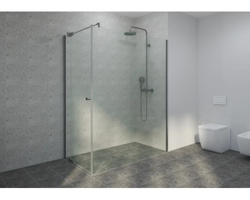 Douche à l'italienne moderne avec paroi en verre sans cadre, système de douche en métal et carrelage aspect béton.
