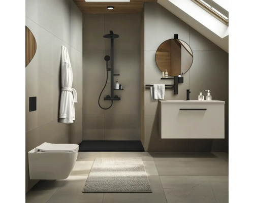 Modernes Badezimmer mit Wand-WC, begehbarer Dusche mit schwarzen Armaturen, Waschtischunterschrank und rundem Spiegel in minimalistischem Design.